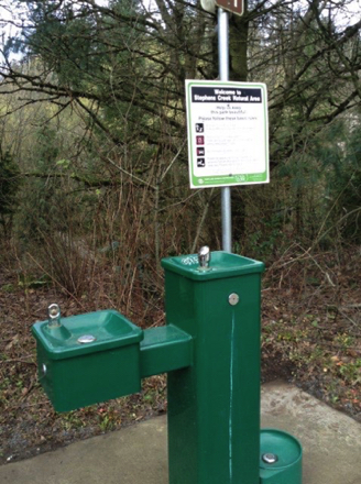 Three-tier drinking fountain - one for dogs - park rules sign